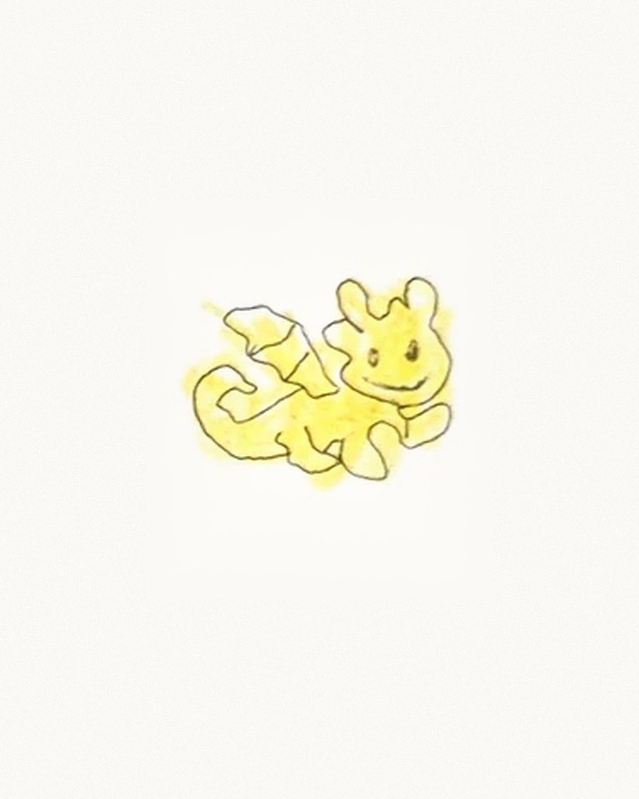 A child's yellow crayon drawing of a smiling cat